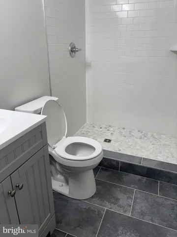 a bathroom with a toilet a sink and a window