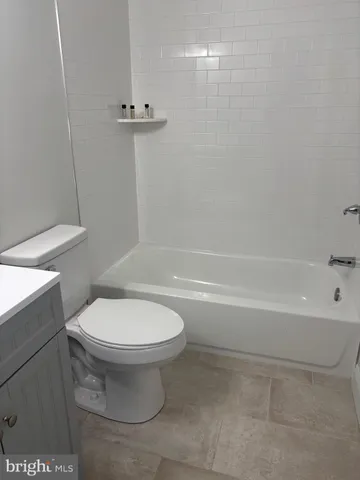 a bathroom with a toilet and a bathtub