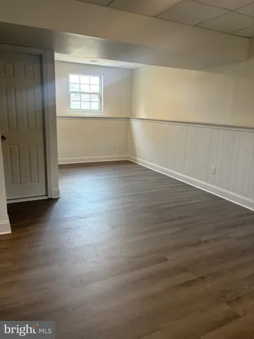 an empty room with wooden floor