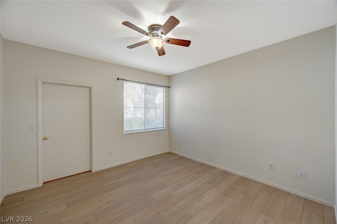 9050 West Warm Springs Road, Unit 1147 Las Vegas, NV 89148 - Photo 21 of 36 Well-lit room with wood plank flooring and a ceiling fan offers a comfortable atmosphere.