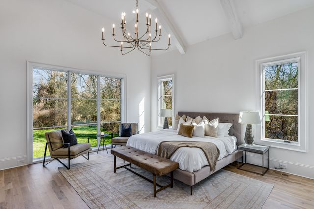 a bedroom with a bed a table and a window