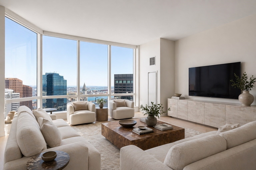 1 Franklin Street, Unit 4704 Boston, MA 02110 - Photo 1 of 33 a living room with furniture and a flat screen tv