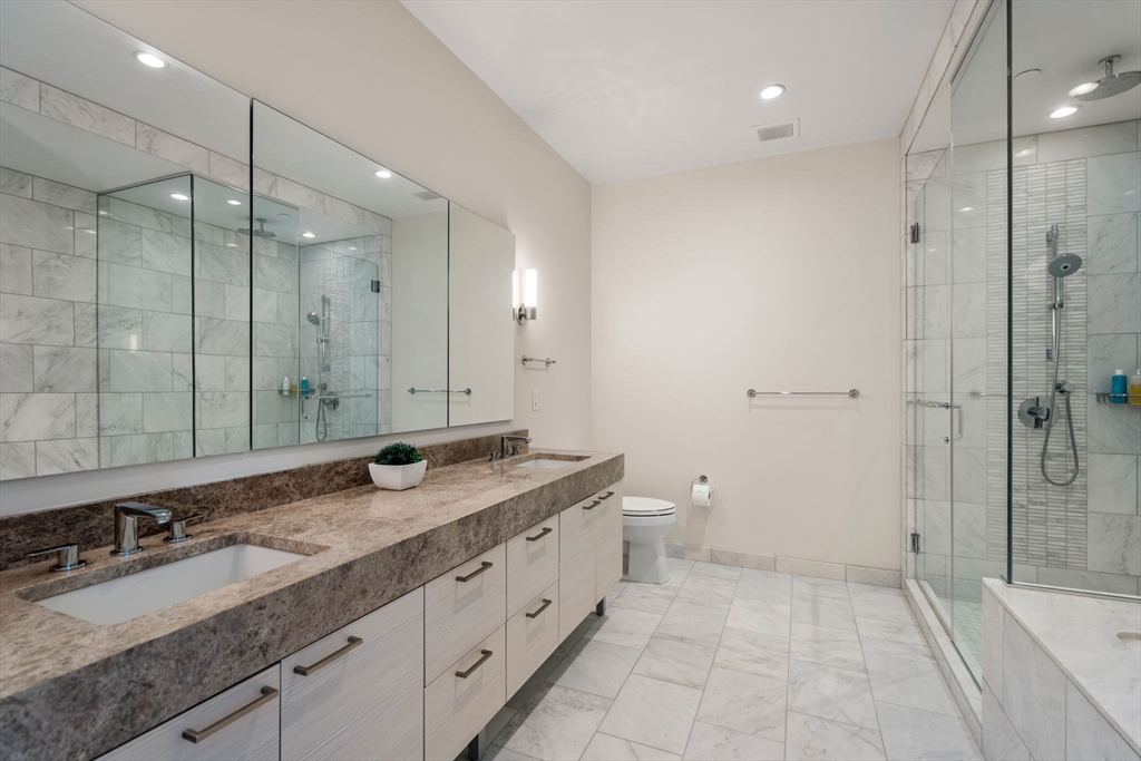 1 Franklin Street, Unit 4704 Boston, MA 02110 - Photo 12 of 33 a bathroom with a granite countertop sink mirror and double