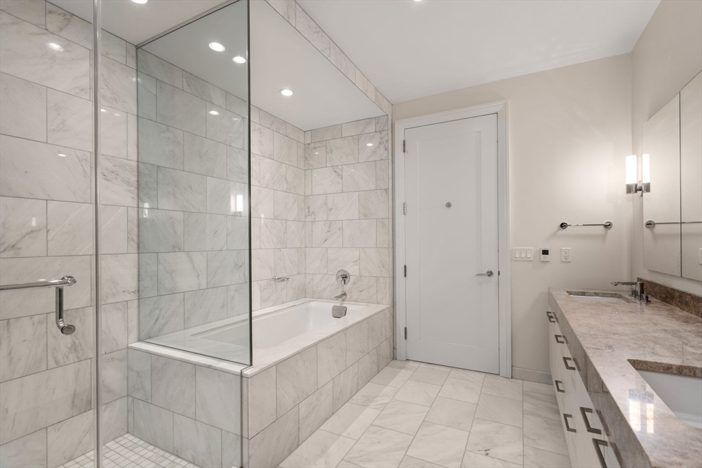 1 Franklin Street, Unit 4704 Boston, MA 02110 - Photo 13 of 33 a bathroom with a bathtub and a shower