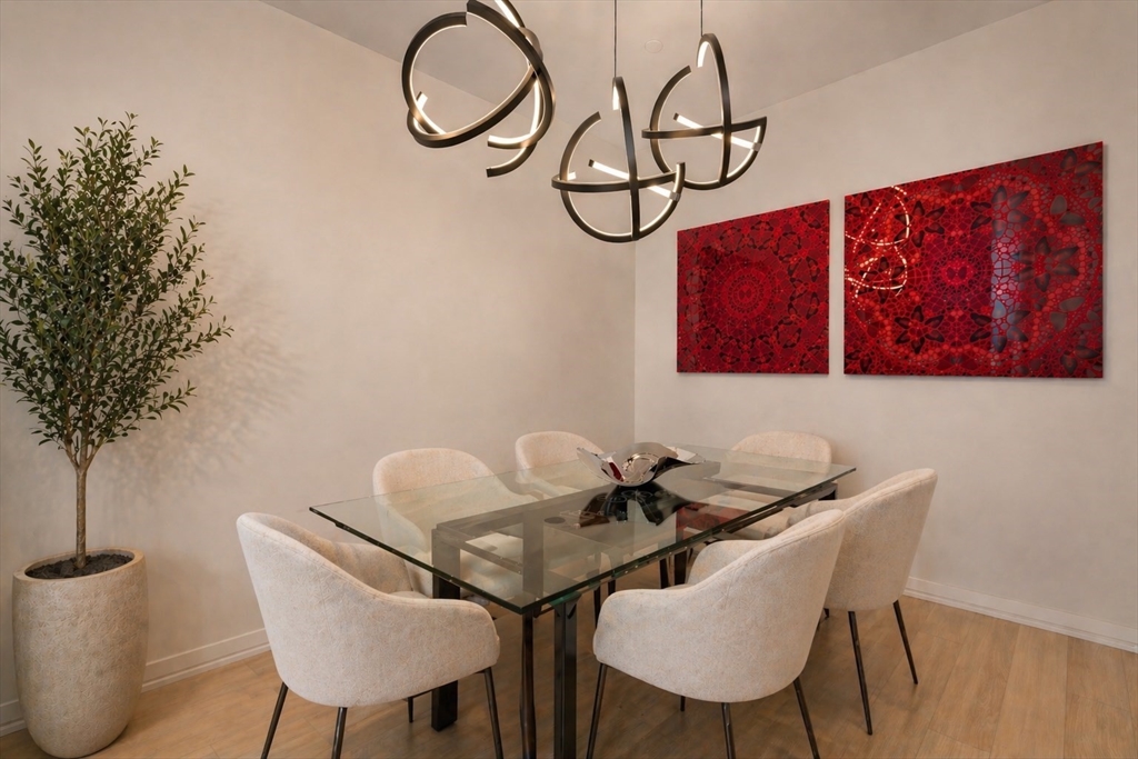 1 Franklin Street, Unit 4704 Boston, MA 02110 - Photo 9 of 33 a view of a dining room with furniture and wooden floor