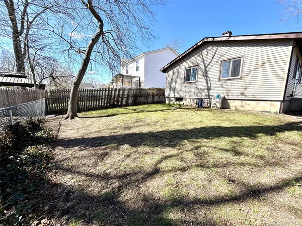 a view of a house with snow on the side of the road