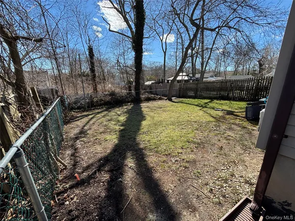 a view of a yard with wooden fence