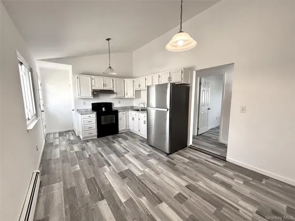 a kitchen with stainless steel appliances a refrigerator sink and microwave