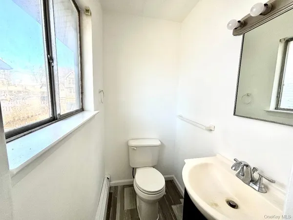 a white toilet sitting next to a bathroom sink