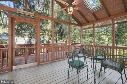 a view of balcony with wooden floor and fence