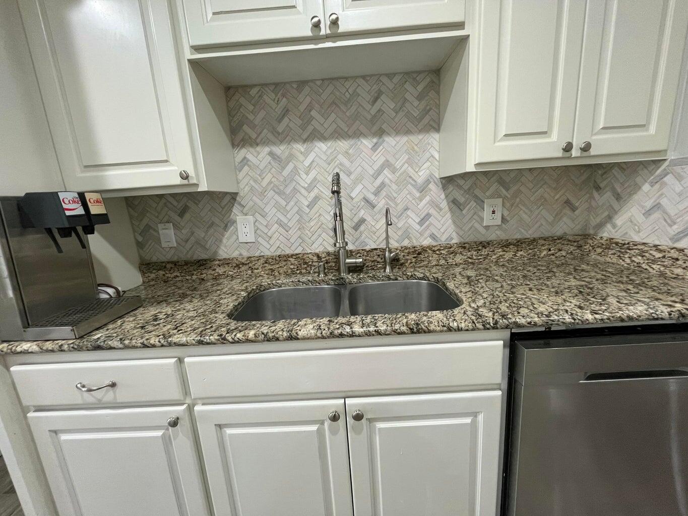 1415 Ebeling Drive Plainview, TX 79072 - Photo 15 of 46 a kitchen with a sink and cabinets