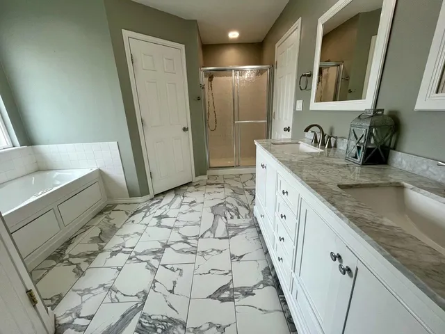 a spacious bathroom with a granite countertop sink and a mirror