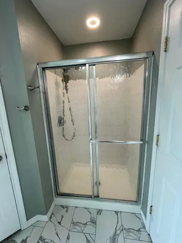 a white toilet sitting next to a sink