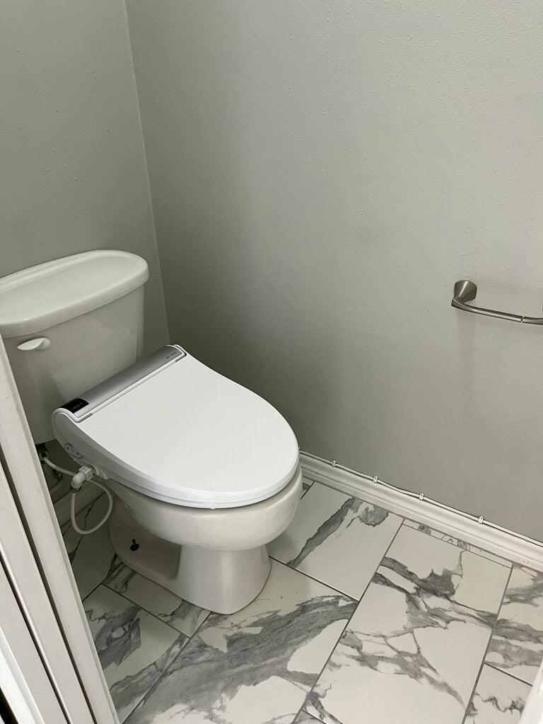 1415 Ebeling Drive Plainview, TX 79072 - Photo 22 of 46 a white toilet sitting next to a sink