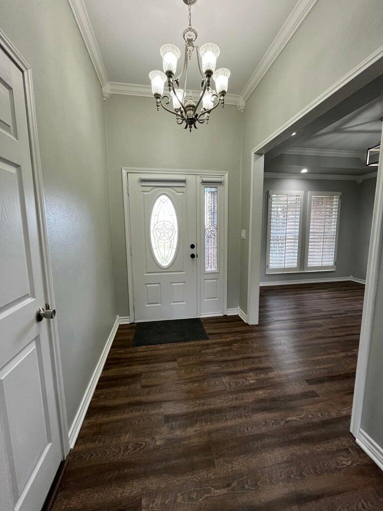 1415 Ebeling Drive Plainview, TX 79072 - Photo 4 of 46 a view of a livingroom with wooden floor and staircase