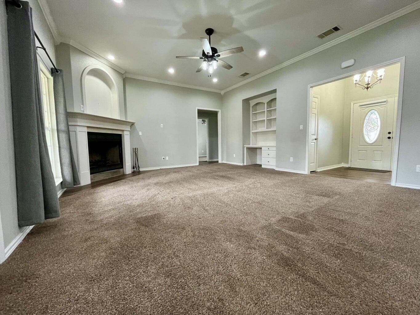 1415 Ebeling Drive Plainview, TX 79072 - Photo 9 of 46 a view of an empty room with window and fireplace