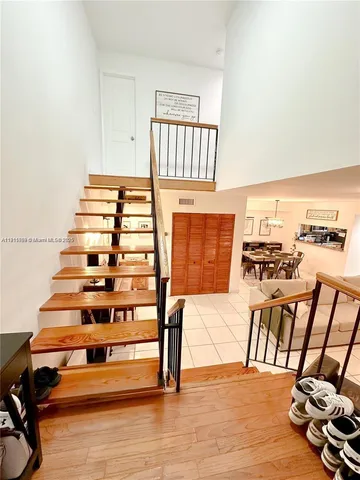 a view of a living room with furniture and a floor to ceiling window