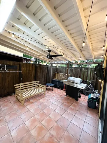 a view of a patio with table and chairs with wooden floor