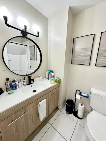 a bathroom with a toilet a sink and a mirror