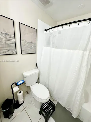 a bathroom with a toilet and a mirror
