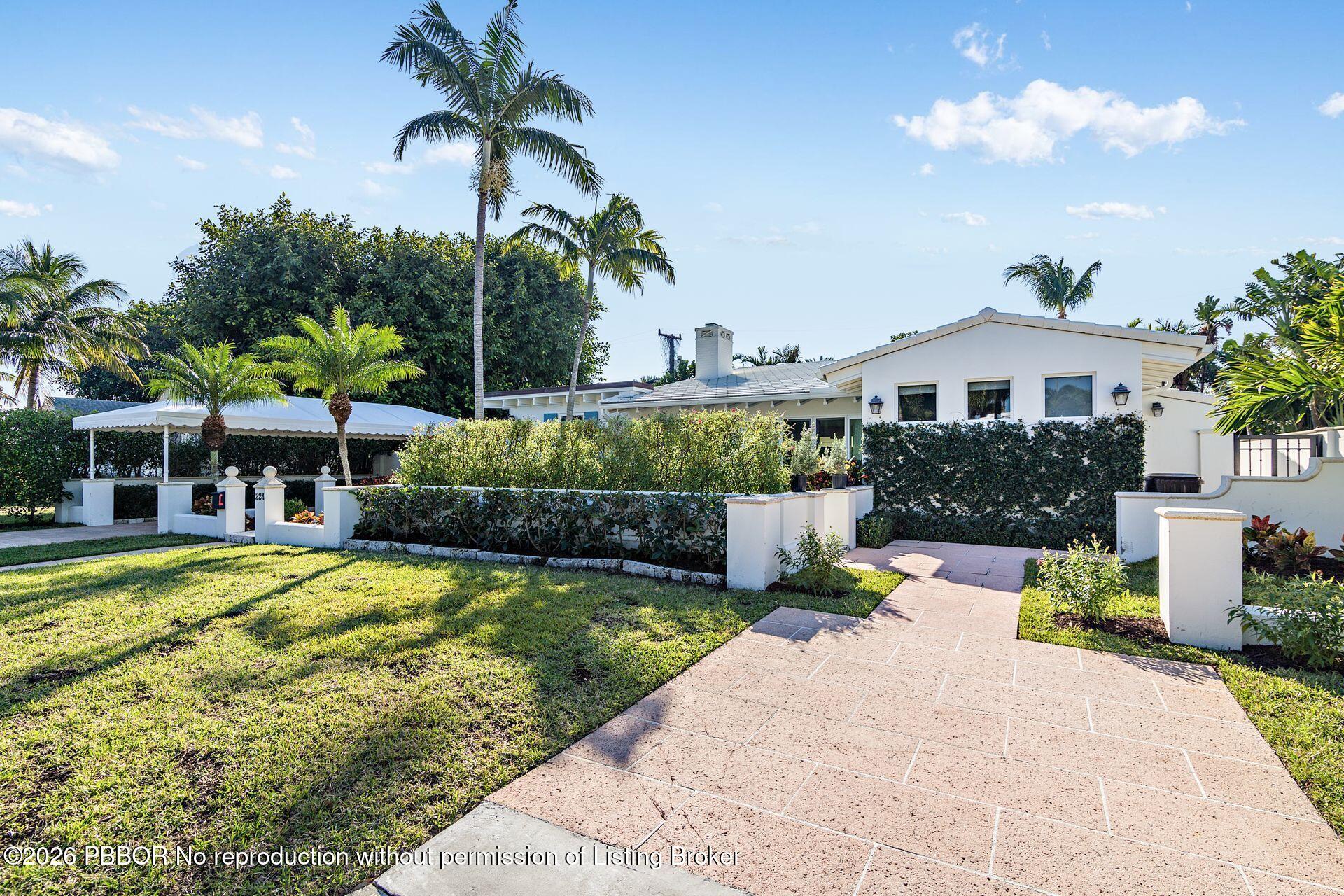 a view of a house with swimming pool and a garden
