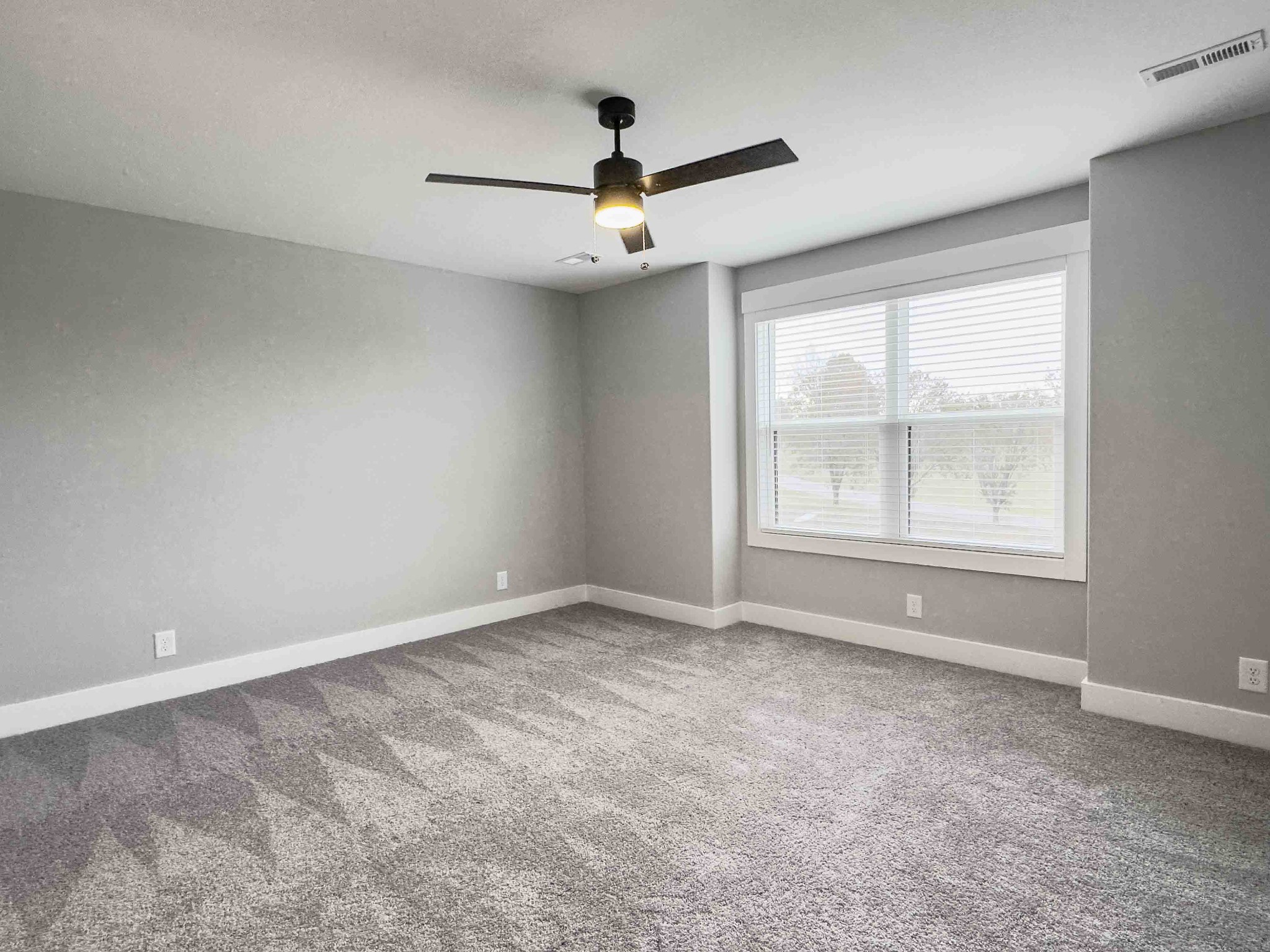 404 Jonathan Wade Circle Clarksville, TN 37043 - Photo 19 of 25 an empty room with ceiling fan and windows