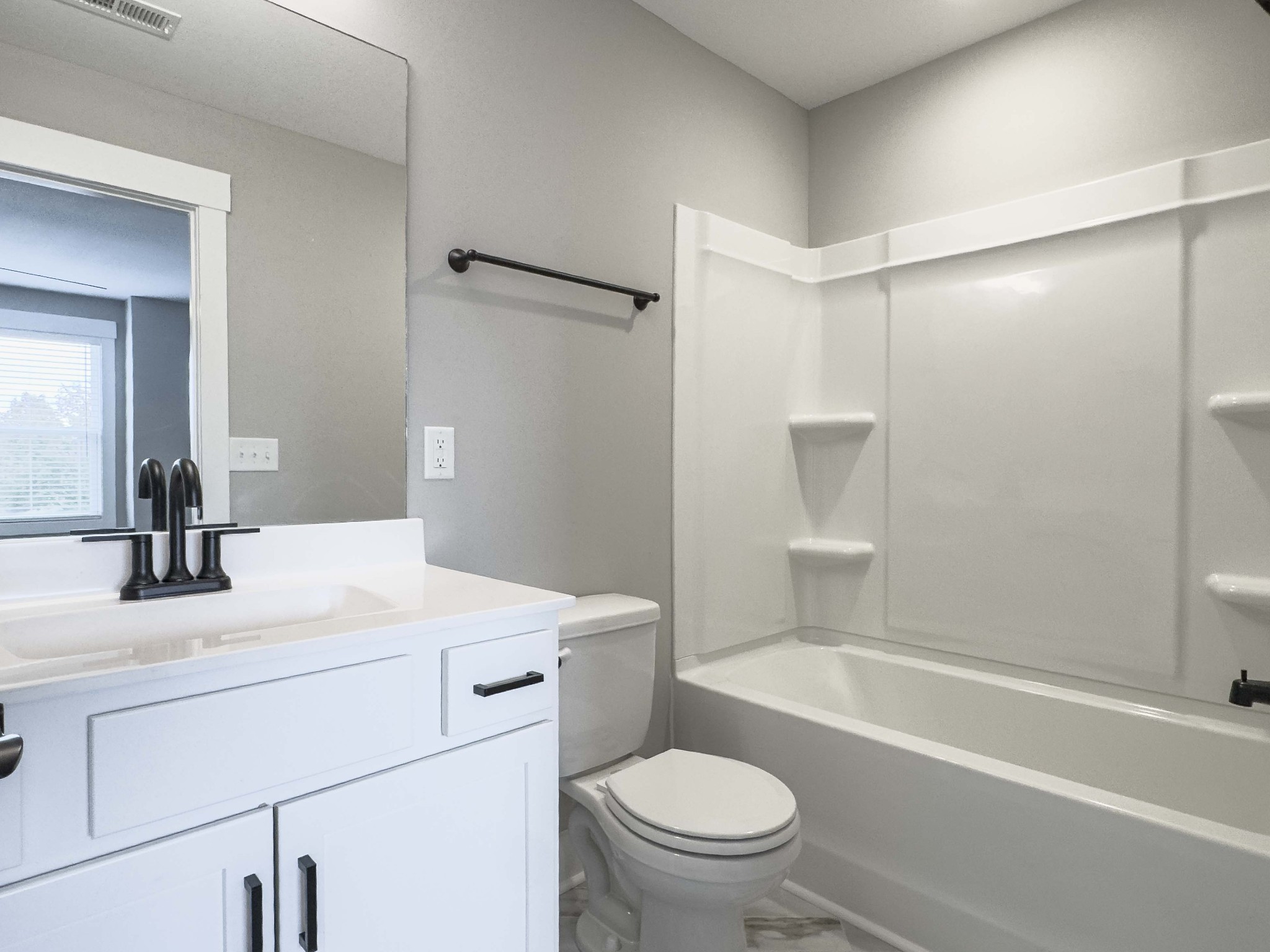 404 Jonathan Wade Circle Clarksville, TN 37043 - Photo 23 of 25 a bathroom with a sink toilet vanity and shower