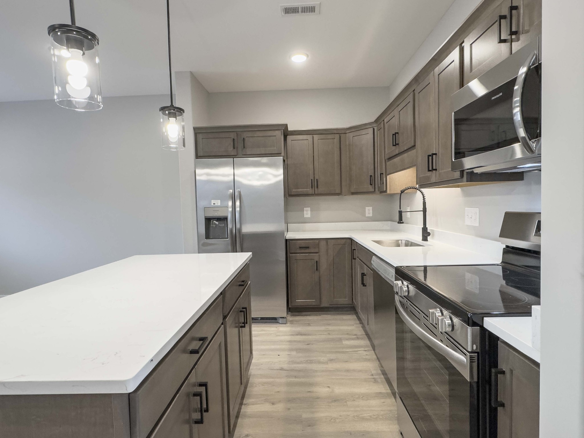 404 Jonathan Wade Circle Clarksville, TN 37043 - Photo 6 of 25 a kitchen with stainless steel appliances granite countertop a sink a stove and a refrigerator