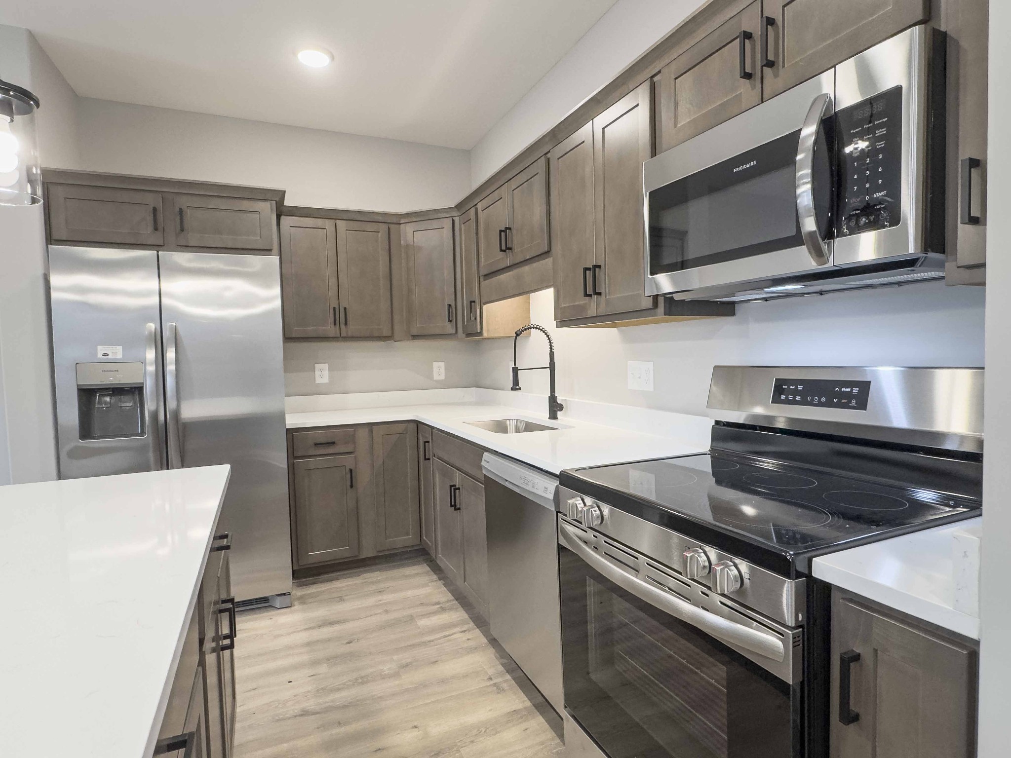 404 Jonathan Wade Circle Clarksville, TN 37043 - Photo 7 of 25 a kitchen with stainless steel appliances a stove microwave and sink