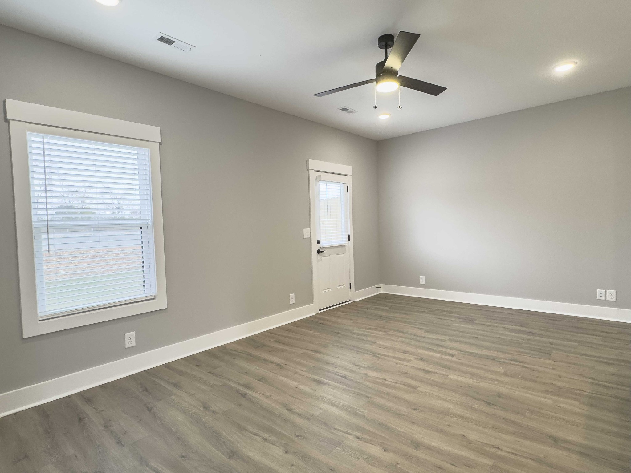 404 Jonathan Wade Circle Clarksville, TN 37043 - Photo 8 of 25 an empty room with wooden floor and windows