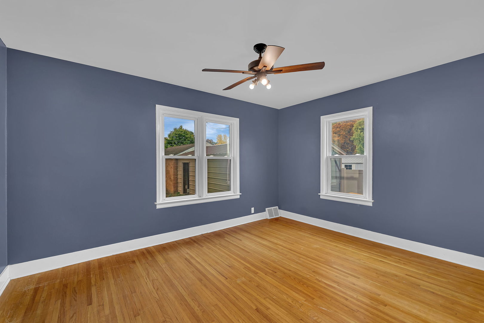 405 West Bluff Street Streator, IL 61364 - Photo 16 of 31 a view of empty room with wooden floor and fan