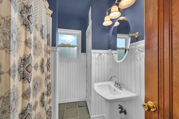 a bathroom with a sink a mirror and a light fixture