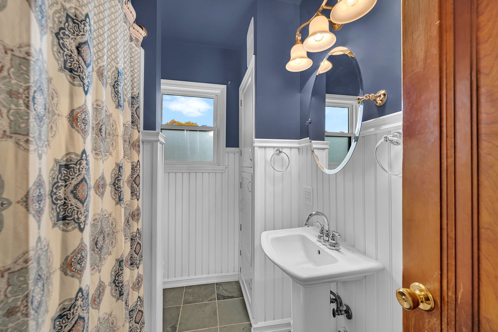 405 West Bluff Street Streator, IL 61364 - Photo 17 of 31 a bathroom with a sink a mirror and a light fixture