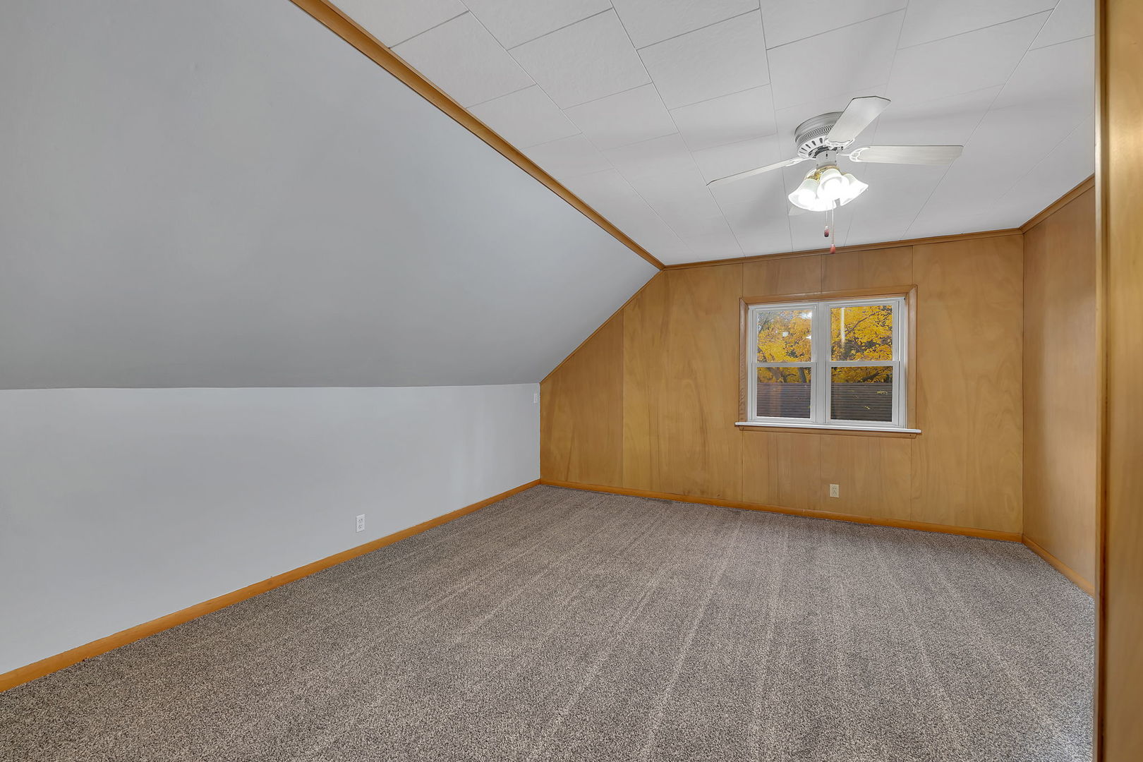 405 West Bluff Street Streator, IL 61364 - Photo 20 of 31 an empty room with a window and a ceiling fan
