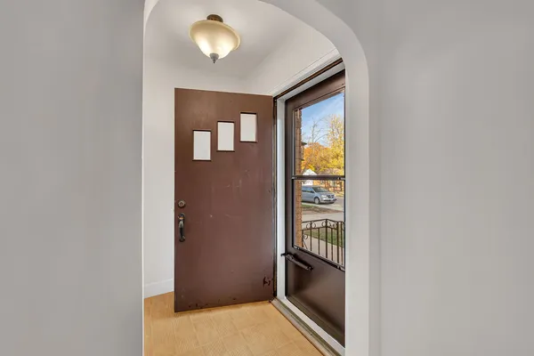a view of a hallway with a window and a refrigerator