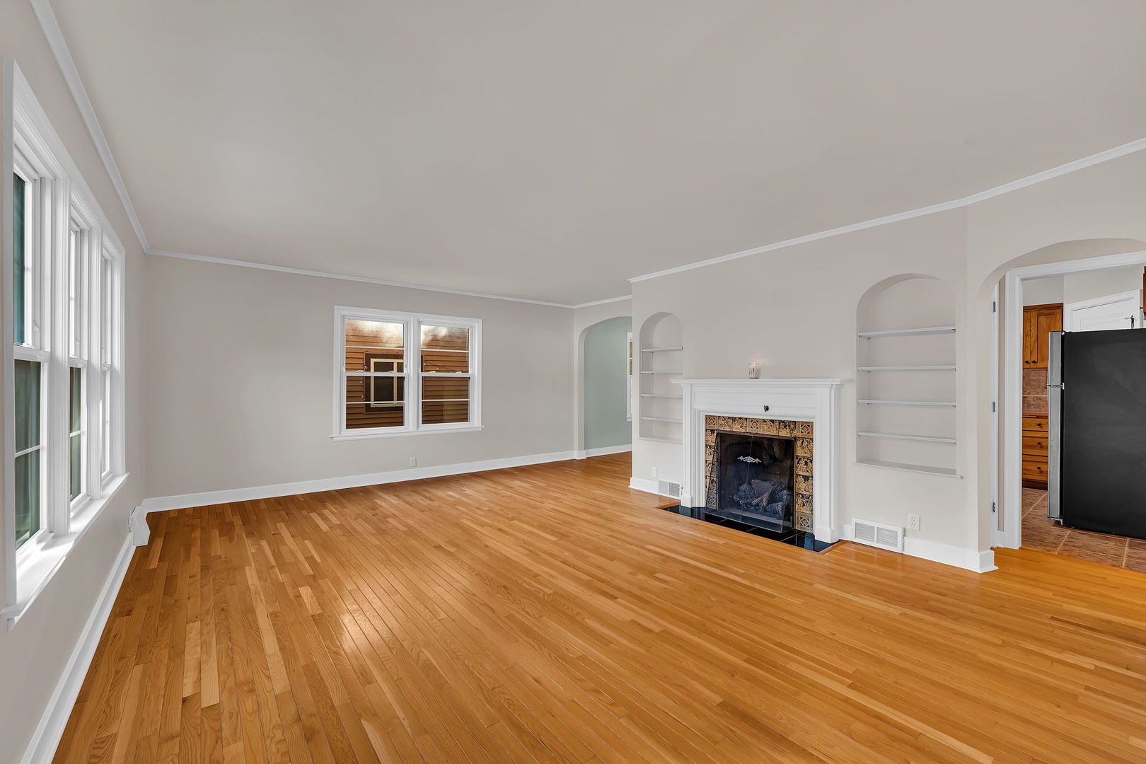 405 West Bluff Street Streator, IL 61364 - Photo 5 of 31 wooden floor fireplace and windows in an empty room