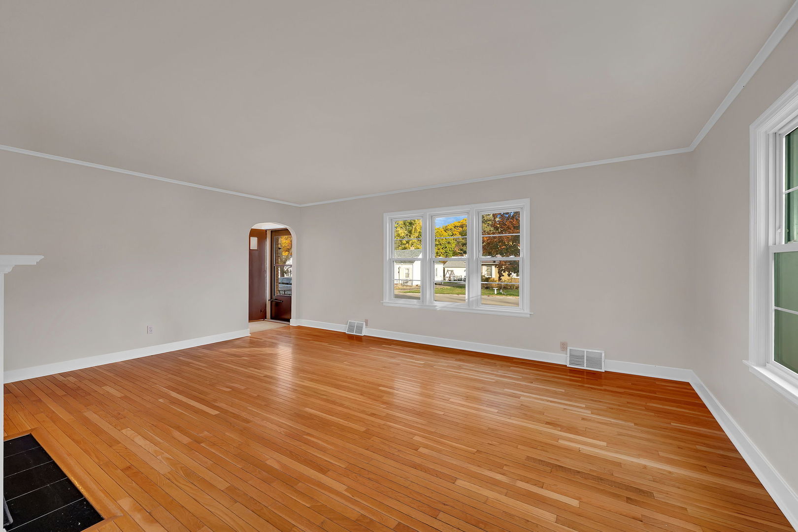 405 West Bluff Street Streator, IL 61364 - Photo 8 of 31 a view of an empty room with wooden floor and a window