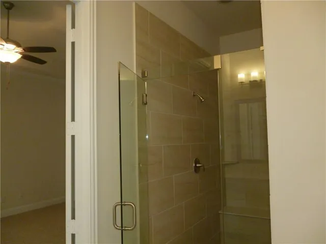 a bathroom with a glass shower door