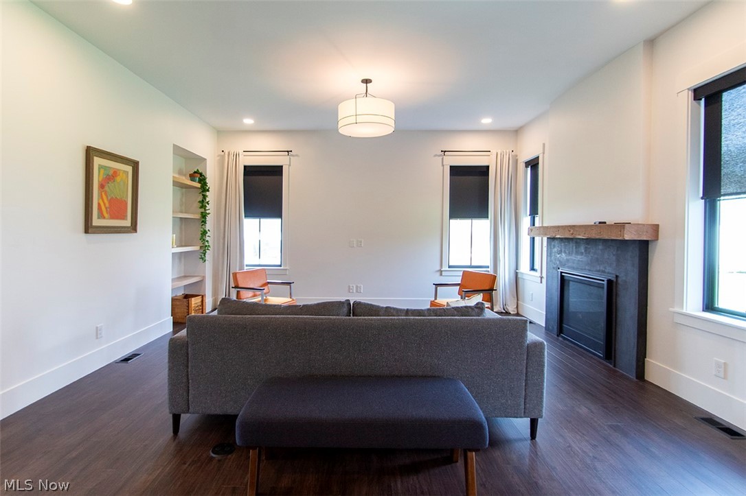 4197 Beach Road Medina, OH 44256 - Photo 12 of 35 Great room with built in shelves, a wealth of natural light, and dark hardwood / wood-style floors