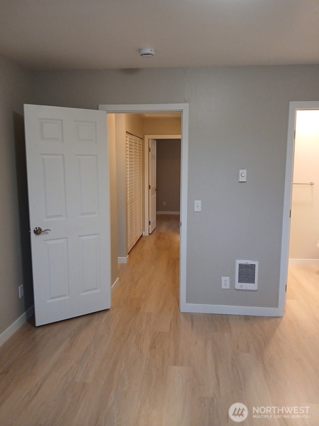 12432 Southeast 272nd Place, Unit B202 Kent, WA 98030 - Photo 19 of 25 a view of a hallway with wooden floor and closet