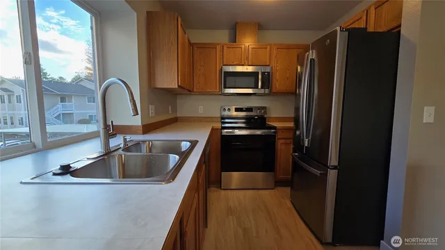 a kitchen with a refrigerator stove and sink