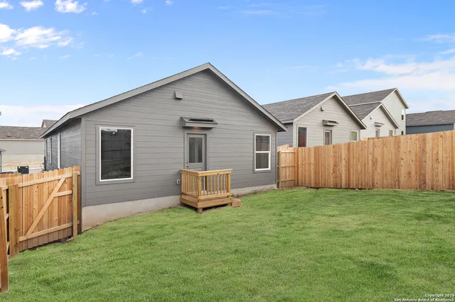 a view of a backyard with a barbeque grill and a fireplace