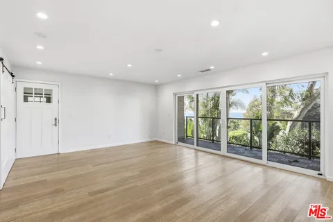 a view of balcony with wooden floor