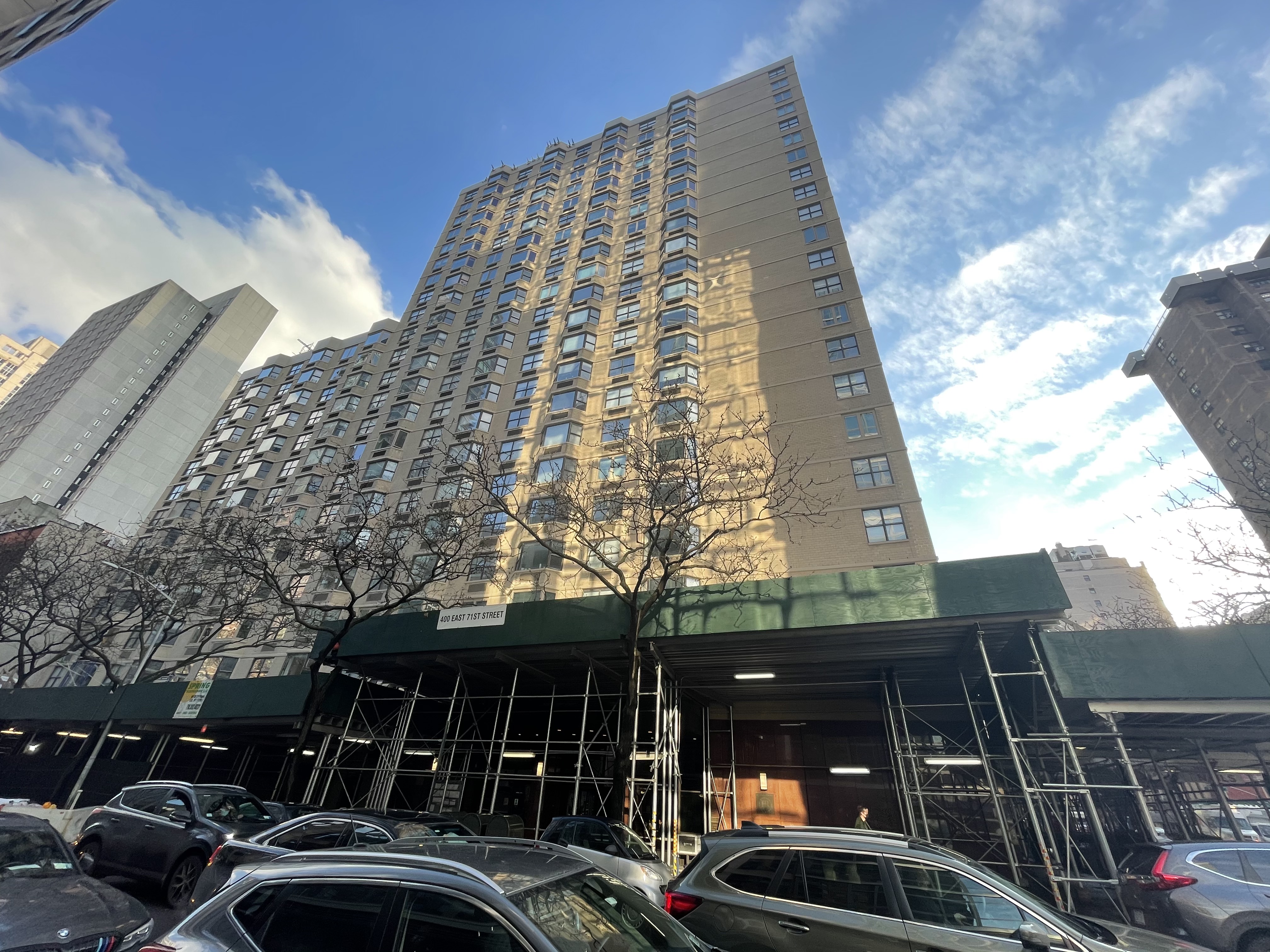 a front view of a building with parking space