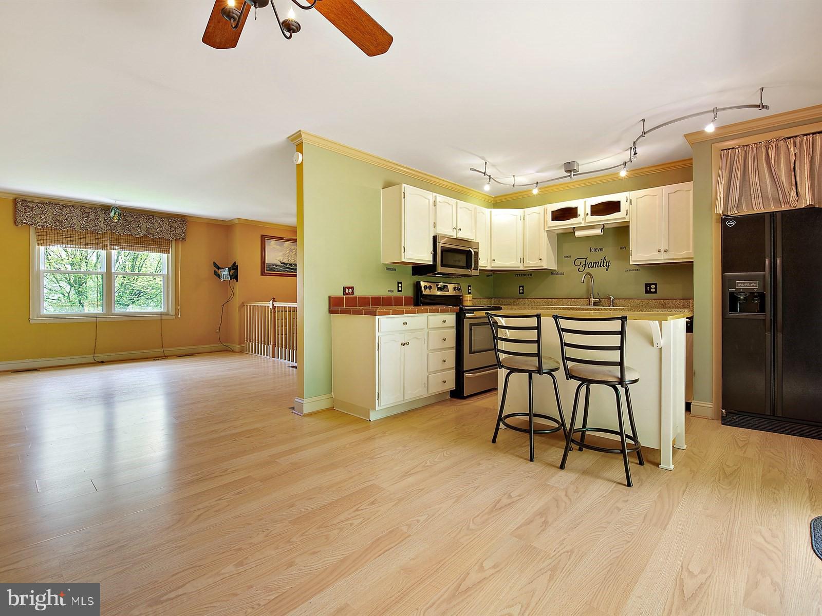 10 Wesley Road Quarryville, PA 17566 - Photo 4 of 25 a kitchen with stainless steel appliances granite countertop a stove a sink dishwasher and a refrigerator with wooden floor