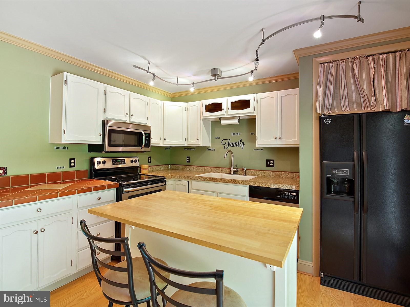 10 Wesley Road Quarryville, PA 17566 - Photo 6 of 25 a kitchen with stainless steel appliances a stove refrigerator sink and cabinets