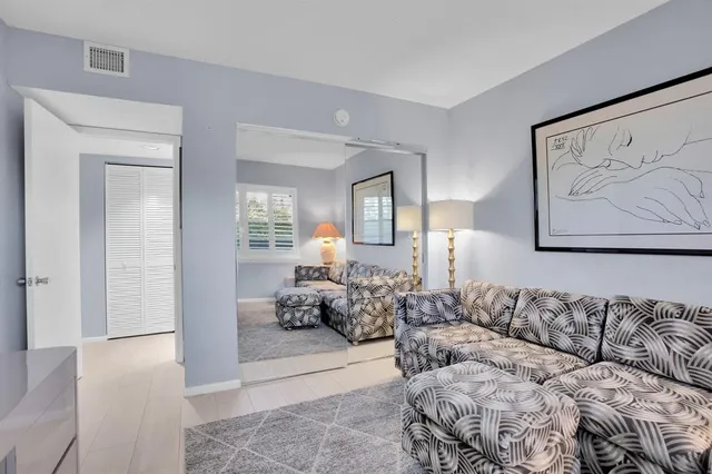 a living room with furniture and painting on the wall