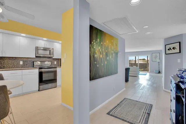 a kitchen with stainless steel appliances a stove a sink and a refrigerator