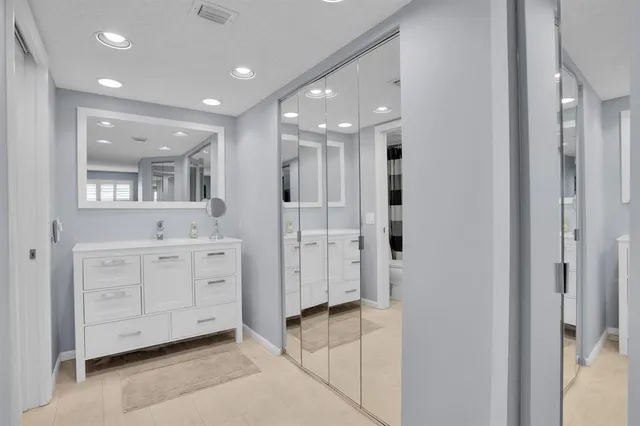 a spacious bathroom with a mirror and a shower