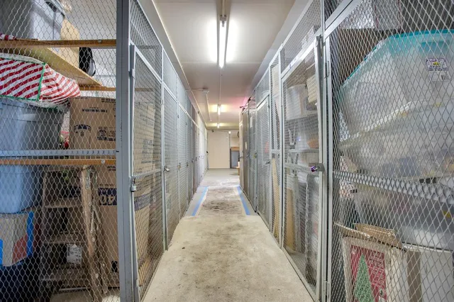 a front view of a building with a garden and plants